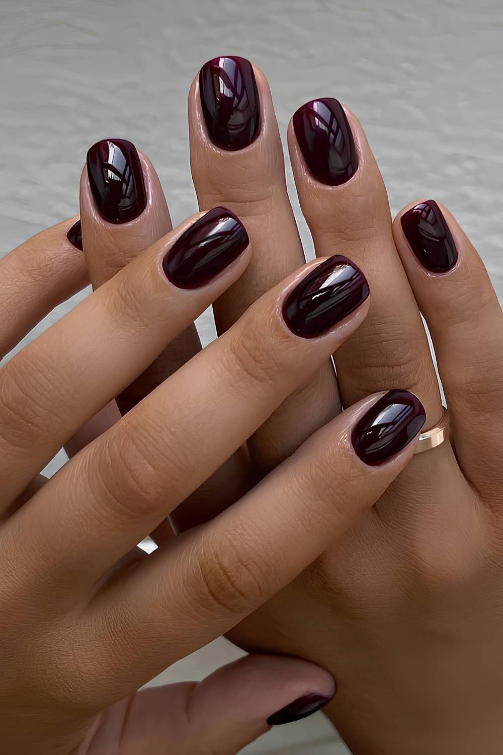 Black cherry short square nails, very dark red gel that reads almost black, on medium brown skin