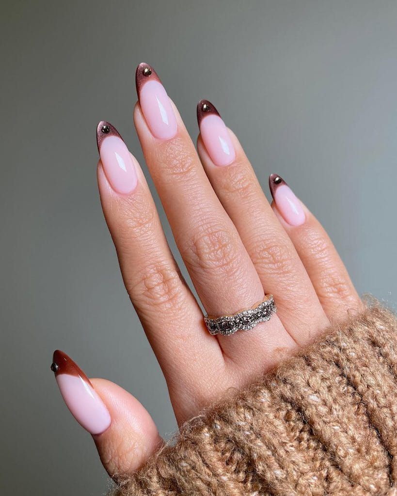 Burgundy French tip nails on a soft pink base, thin dark red tips on long almond nails